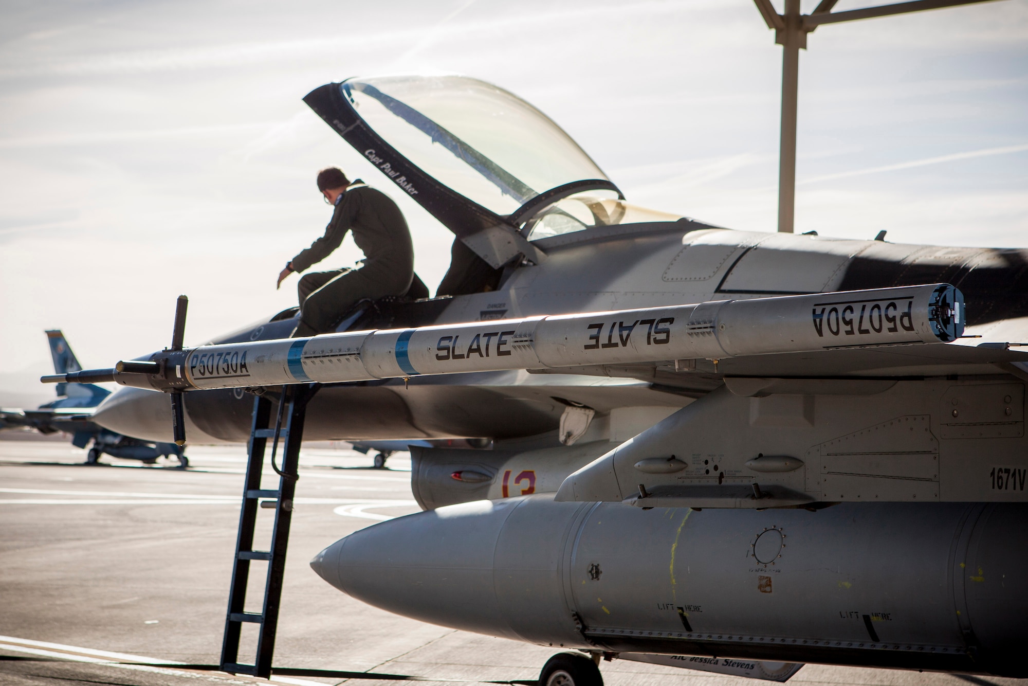 The Secure Live Virtual Constructive Advanced Training Environment (SLATE) LVC pod is attached to an F-16 with the 64th Aggressor Squadron during an Electromagnetic Interference/Compatibility test at Nellis AFB, Nevada, during Phase I of the demonstration in June. (U.S. Air Force photo/William Graver)