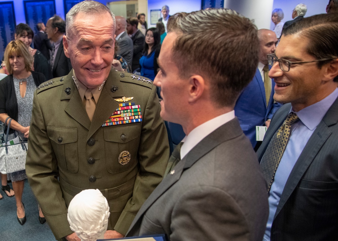Marine Corps Gen. Joe Dunford, chairman of the Joint Chiefs of Staff, speaks to James Ferguson, founder of the Warrior Reunion Foundation of Cockeysville, Maryland, during the 2018 Newman’s Own Awards at the Hall of Heroes in the Pentagon, Oct. 5, 2018. The annual competition seeks to reward ingenuity for programs that benefit service men, women, and their families. DoD photo by Navy Petty Officer 1st Class Dominique A. Pineiro