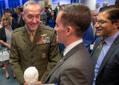 Marine Corps Gen. Joe Dunford, chairman of the Joint Chiefs of Staff, speaks to James Ferguson, founder of the Warrior Reunion Foundation of Cockeysville, Maryland, during the 2018 Newman’s Own Awards at the Hall of Heroes in the Pentagon, Oct. 5, 2018. The annual competition seeks to reward ingenuity for programs that benefit service men, women, and their families. DoD photo by Navy Petty Officer 1st Class Dominique A. Pineiro