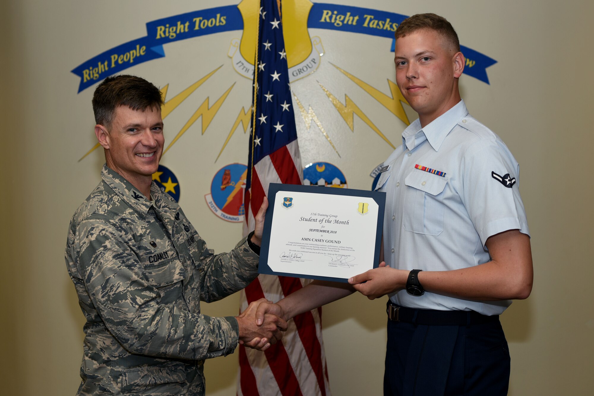 U.S. Air Force Col. Thomas Coakley, 17th Training Group commander, presents the 312th Training Squadron Student of the Month award to Airman Casey Gound, 312th TRS student, at Brandenburg Hall on Goodfellow Air Force Base, Texas, Oct. 5, 2018. The 312th TRS’s mission is to provide Department of Defense and international customers with mission ready fire protection and special instruments graduates and provide mission support for the Air Force Technical Applications Center. (U.S. Air Force photo by 2nd Lt. Matthew Stott/Released)