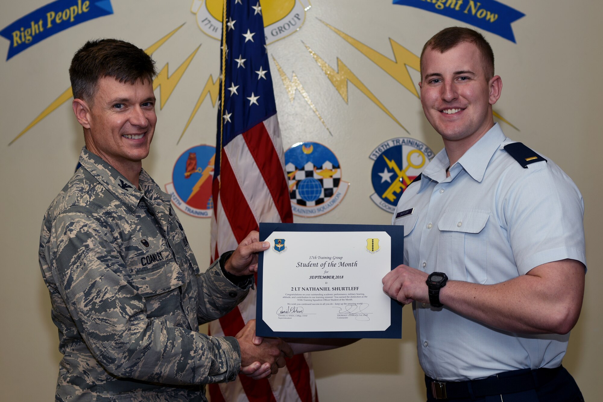 U.S. Air Force Col. Thomas Coakley, 17th Training Group commander, presents the 315th Training Squadron Officer Student of the Month award to 2nd Lt. Nathaniel Shurtleff, 315th TRS student, at Brandenburg Hall on Goodfellow Air Force Base, Texas, Oct. 5, 2018. The 315th TRS’s vision is to develop combat-ready intelligence, surveillance and reconnaissance professionals and promote an innovative squadron culture and identity unmatched across the U.S. Air Force. (U.S. Air Force photo by 2nd Lt. Matthew Stott/Released)