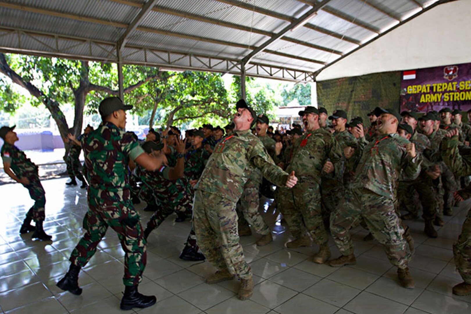 Soldiers with the Indiana Army National Guard's 76th Infantry Brigade Combat Team and their Indonesian counterparts from the Tentara Nasional Indonesia army kick off Garuda Shield 18 by conducting a "Yel-Yel," a cry-and-response war dance, July 29, 2018, in Indonesia. Garuda Shield 18 is the third exercise in U.S. Army Pacific's second iteration of Pacific Pathways, a series of multinational engagements with ally and partner militaries in the Indo-Pacific region.