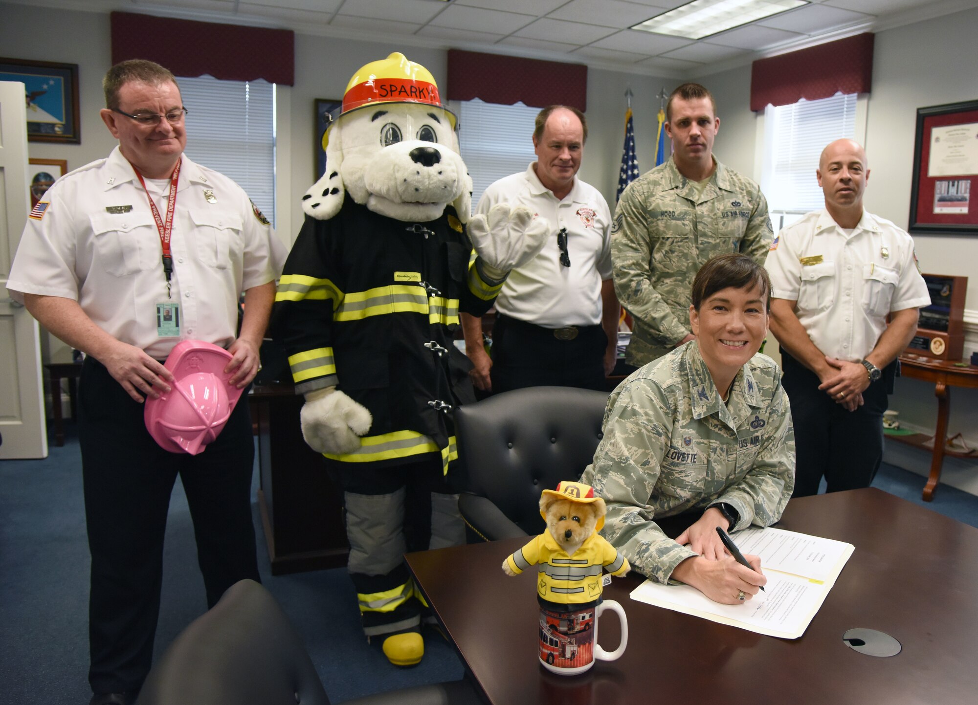 U.S. Air Force Col. Debra Lovette, 81st Training Wing commander, signs the Fire Prevention Week Declaration at the 81st TRW headquarters building on Keesler Air Force Base, Mississippi, Oct. 9, 2018. The week-long event includes fire drills, literature hand-outs and stove fire demonstrations around the base and concludes with an open house at the fire department on Oct. 13. (U.S. Air Force photo by Kemberly Groue)