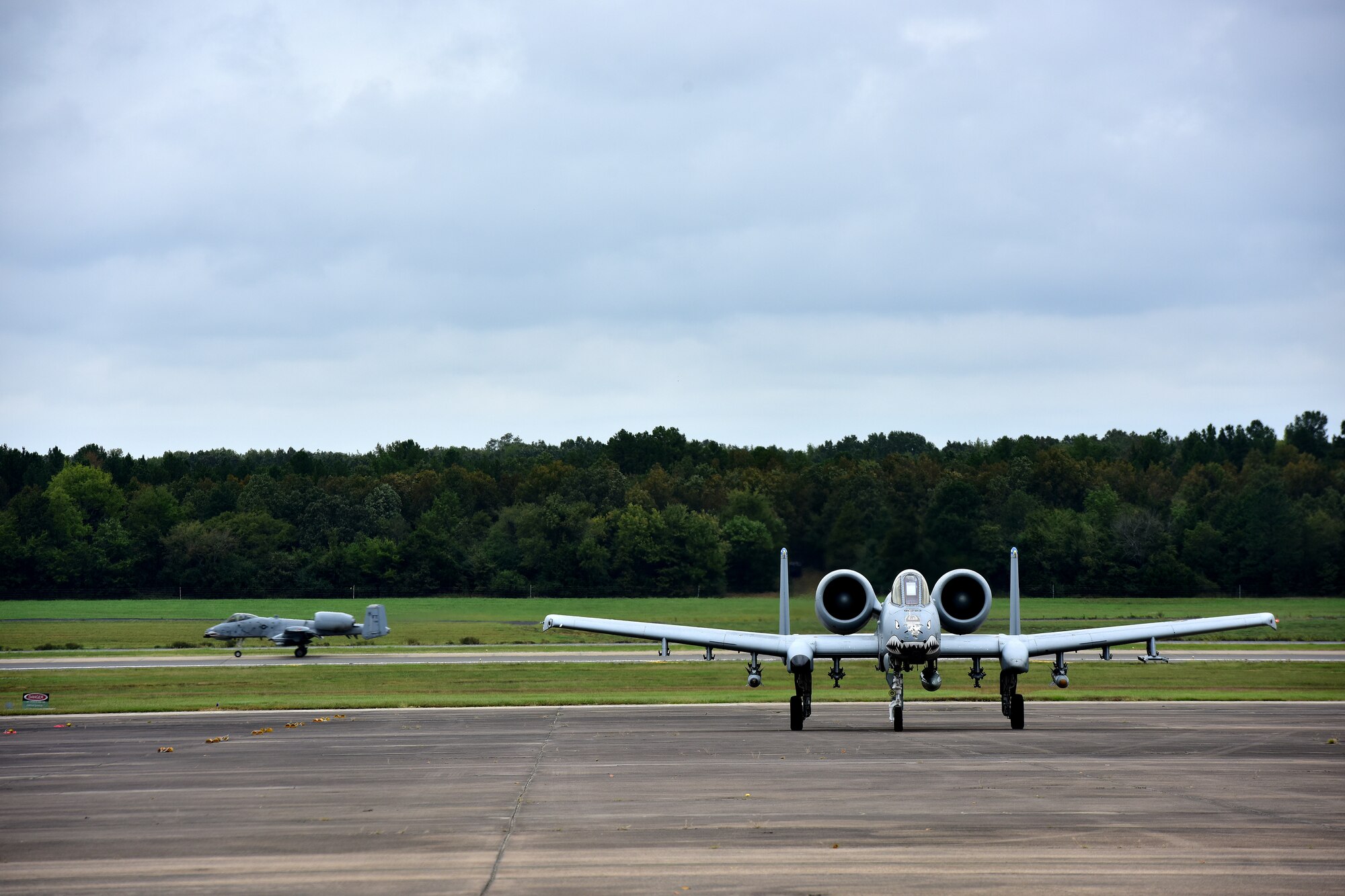 Aircraft land on a runway.