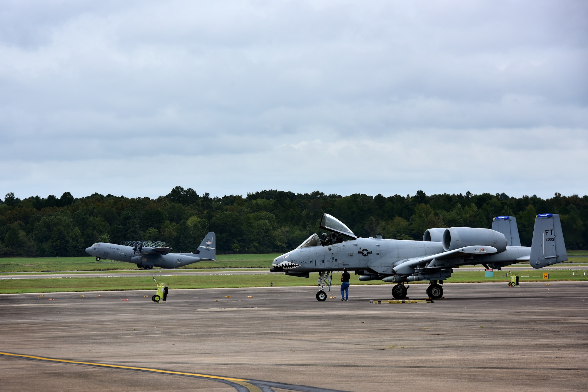 Aircraft land on a runway.