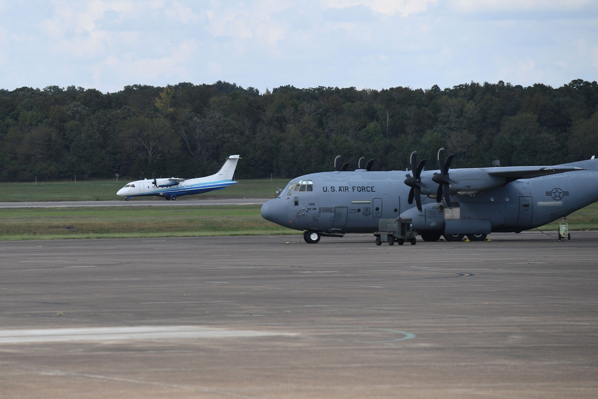 Aircraft land on a runway.