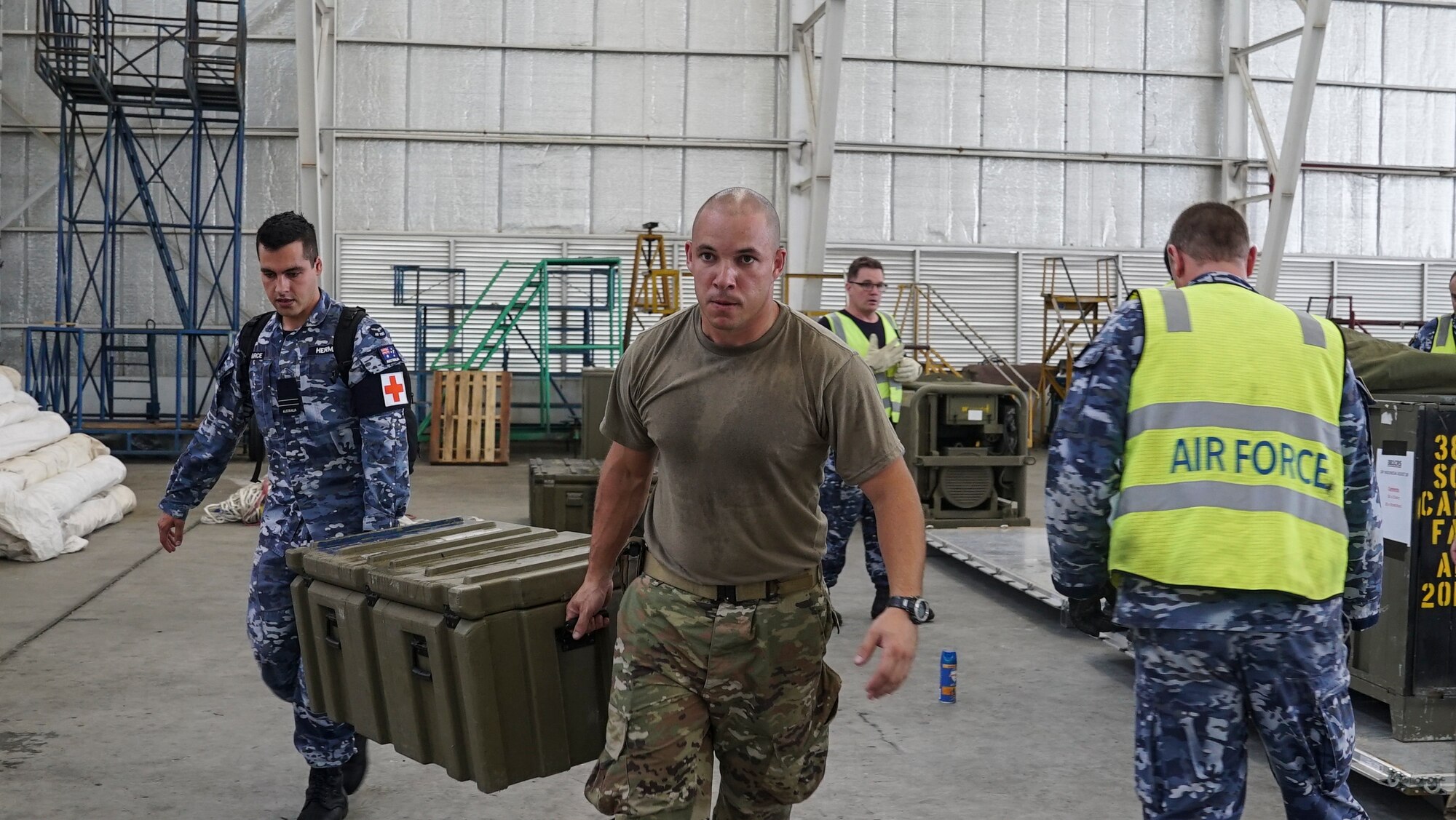 U.S. Air Force Tech Sgt. Eliezer Ribeiro, 36th Contingency Response Group vehicle maintenance NCO in charge at Andersen Air Force Base, helps Royal Australian Air Force medical personnel offload supplies in Balikpapan, Indonesia. The Indonesian Government and U.S. Agency for International Development are working alongside eight countries agencies and foreign militaries ensuring supplies, airlift, shelter and medical support reach those affected. (U.S. Air Force photo by Master Sgt. JT May III)