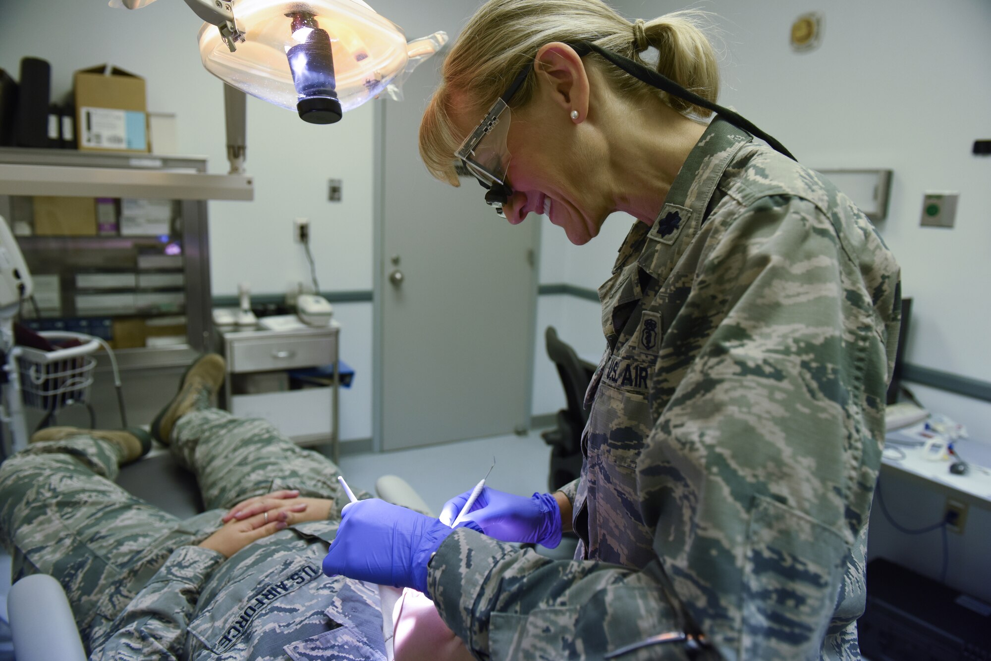 Lt. Col. Nicole Yingling, a dentist with the 193rd Special Operations Medical Group, Middletown, Pennsylvania, performs a routine checkup on an Airman Sept. 22, 2018. Yingling served 11 years as an active duty dentist and after a 12-year break-in-service, enlisted into the 193rd SOMDG. (U.S. Air National Guard photo by Senior Airman Julia Sorber/Released)
