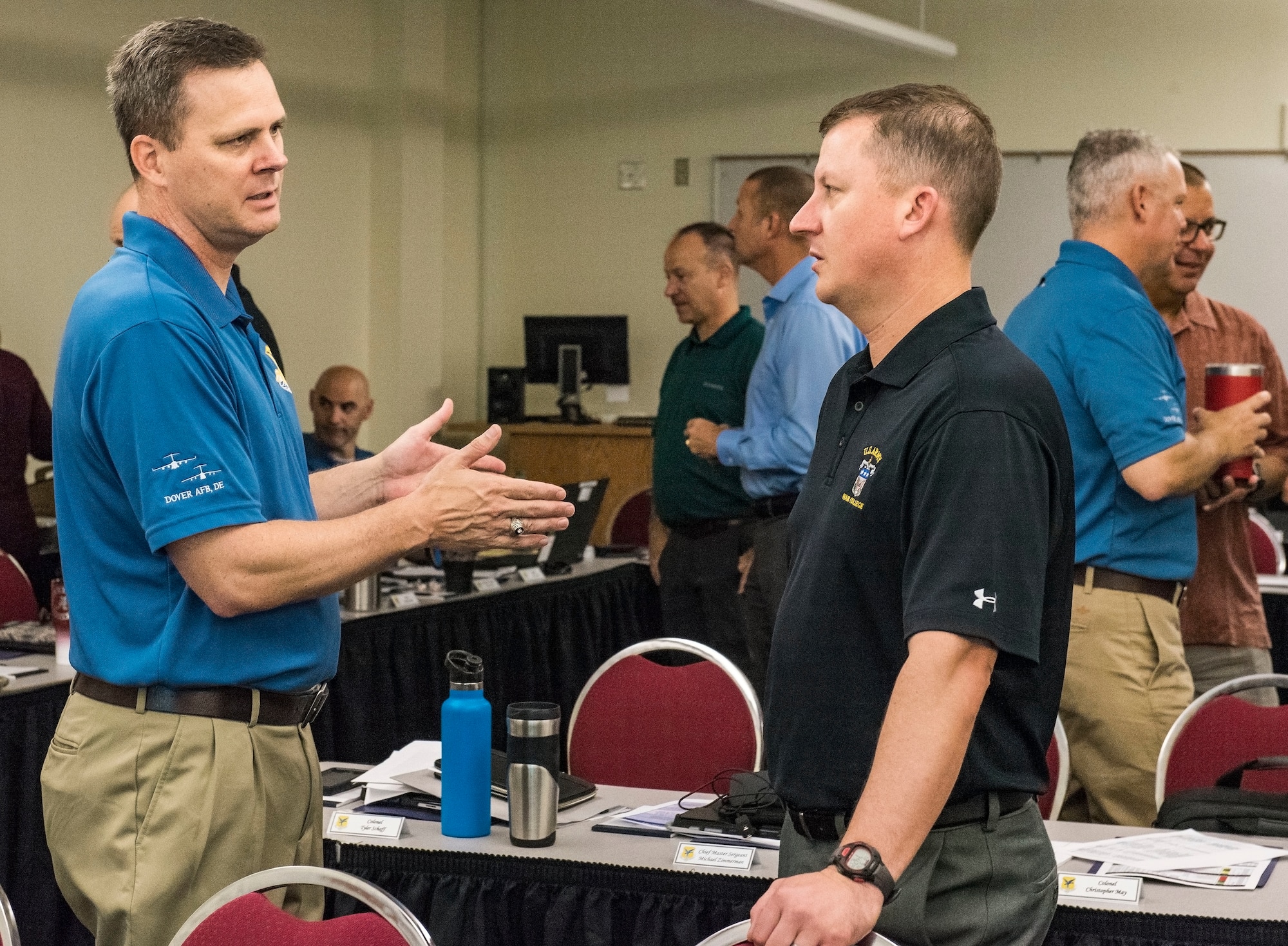 Col. Joel Safranek (left), 436th Airlift Wing commander, speaks with Col. Matthew Jones, 436th AW vice commander, prior to a 436th AW leadership offsite meeting Sept. 13, 2018, at Delaware Technical Community College in Dover, Del. During his opening remarks, Safranek expressed what his expectations were for the two-day offsite. (U.S. Air Force photo by Roland Balik)