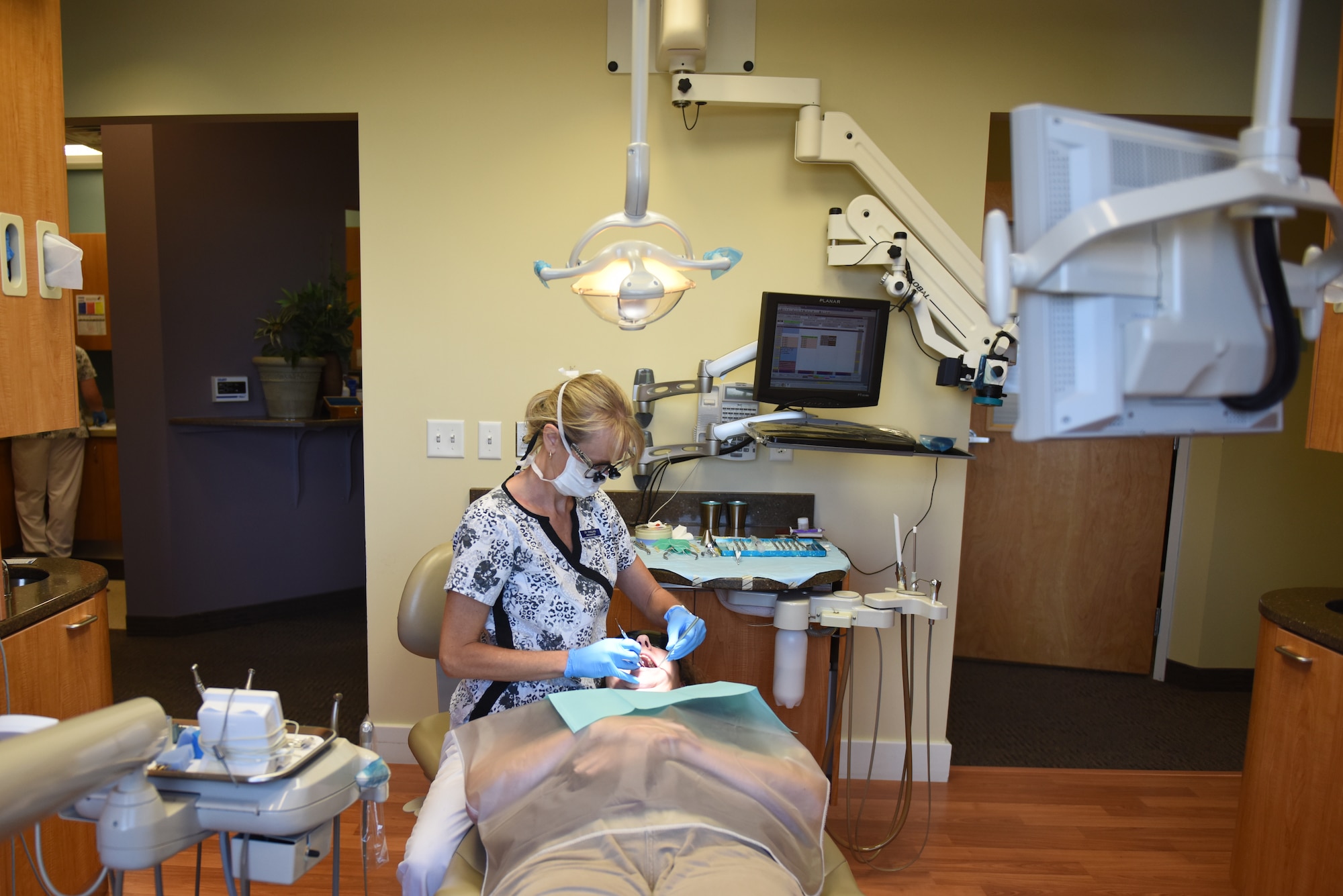 Dr. Nicole Yingling, endodontist and owner of Mason-Dixon Endodontics, Chambersburg, Pennsylvania, examines a patient’s mouth for the reason that they are having mouth pain Oct. 1, 2018. Yingling began her career as a general dentist and later specialized in endodontics, which focuses on the treatment of root canals. Yingling served 11 years as an active duty dentist and after a 12-year break-in-service, enlisted into the 193rd Special Operations Medical Group, Middletown, Pennsylvania. (U.S. Air National Guard photo by Senior Airman Julia Sorber/Released)