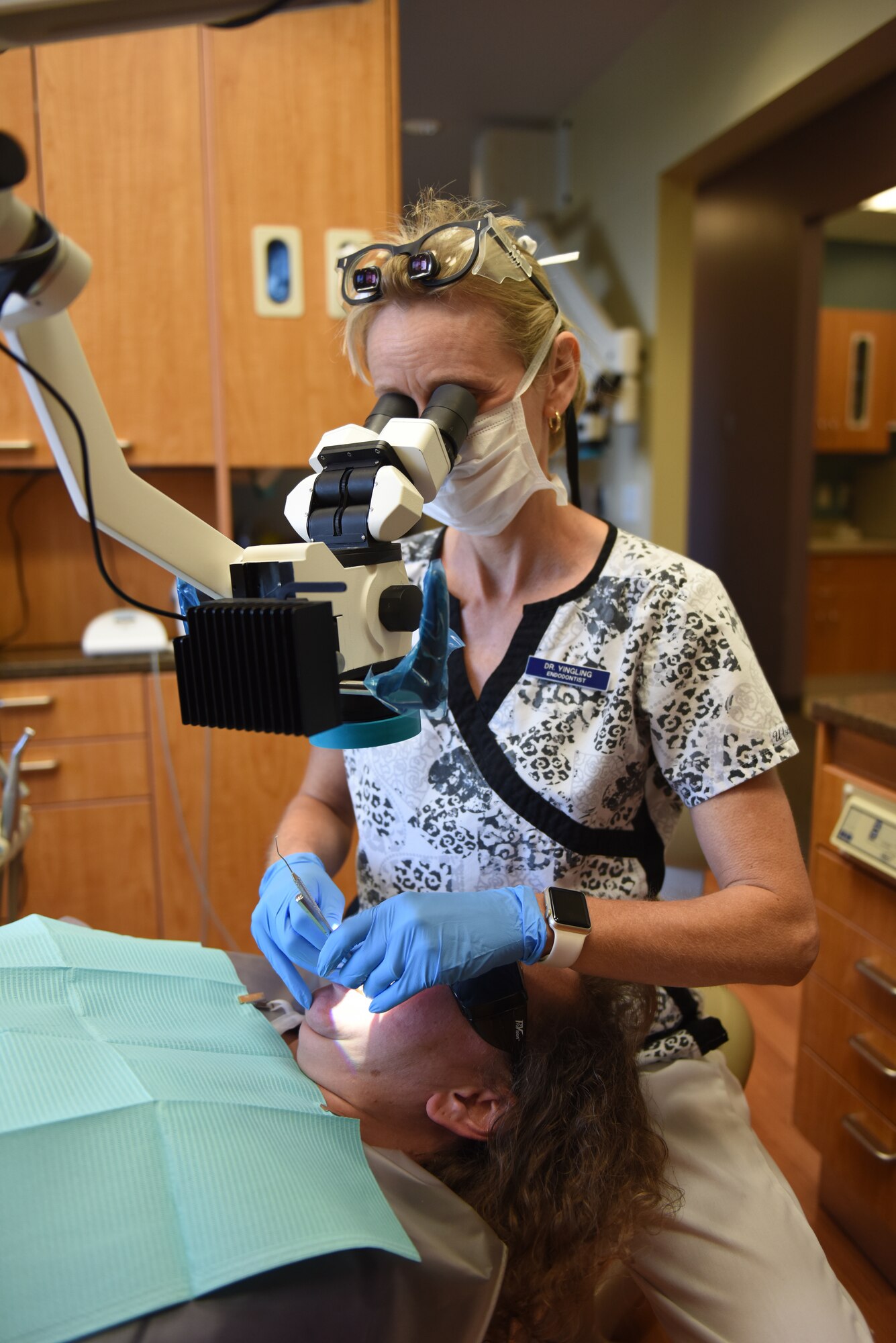 Dr. Nicole Yingling, endodontist and owner of Mason-Dixon Endodontics, Chambersburg, Pennsylvania, looks through an operating microscope to get a closer look at a cracked tooth Oct. 1, 2018. Yingling served 11 years as an active duty dentist and after a 12-year break-in-service, enlisted into the 193rd Special Operations Medical Group, Middletown, Pennsylvania. (U.S. Air National Guard photo by Senior Airman Julia Sorber/Released)