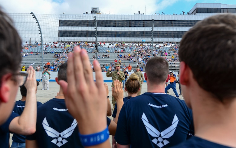 Delayed Entry Program enlistees repeat the oath of enlistment Oct. 7, 2018, administered by Maj. Gen. Peter Gersten, U.S. Air Force Warfare Center commander, Nellis Air Force Base, Nev., at the Dover International Speedway in Dover, Del. Soon, these enlistees will be sent to their respective basic military training installations. (U.S. Air Force photo by Airman First Class Dedan D. Dials)