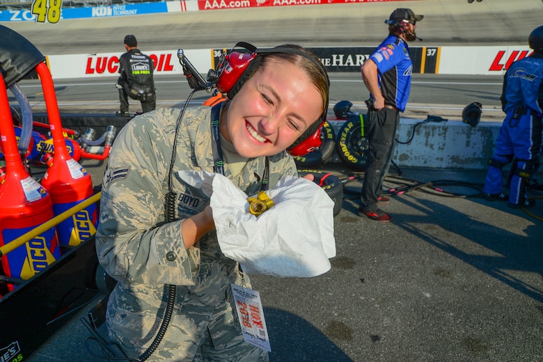 Airman 1st Class Georgie Boyd, 436th Security Forces Squadron response force leader, smiles after receiving lug nuts from a NASCAR driver’s wheels during the “Gander Outdoors 400” Monster Energy NASCAR Cup Series race Oct. 7, 2018, at the Dover International Speedway in Dover, Del. Boyd was selected to be an honorary pit crew member where she got to be up close and personal with David Patrick Ragan, driver of the No. 38 car, and his crew. (U.S. Air Force photo by Airman First Class Dedan D. Dials)