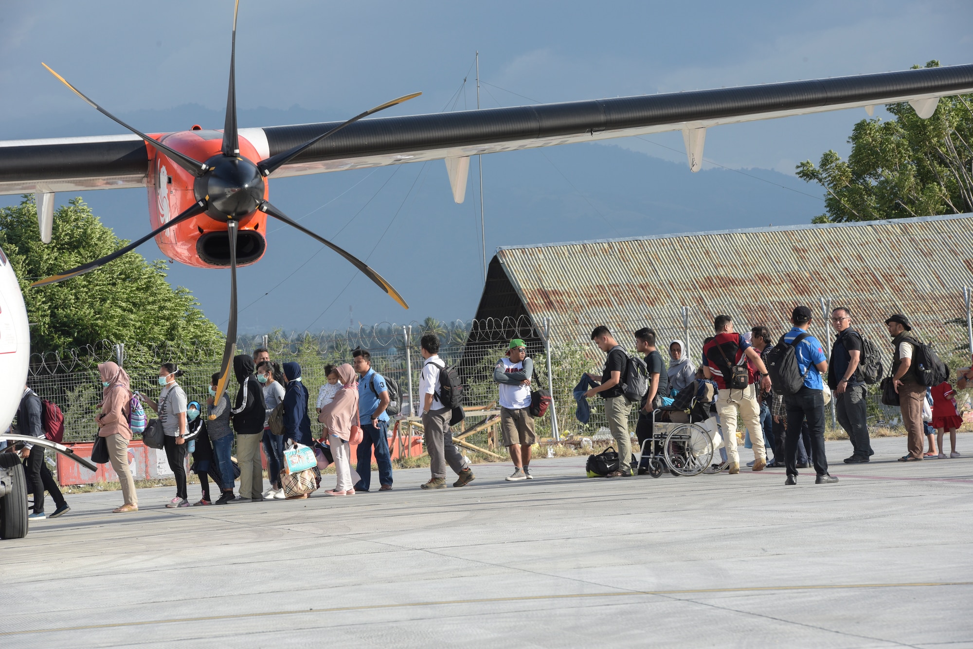 Evacuees prepare to board aircraft in Palu, Indonesia Oct. 6, 2018 after thousands were displaced after a 7.5 magnitude earthquake and tsunami struck Indonesia’s Sulawesi Island Sept. 28, 2018. The Indonesian Government and U.S. Agency for International Development are working alongside eight countries agencies and foreign militaries ensuring supplies, airlift, shelter and medical support reach those affected. (U.S. Air Force photo by Master Sgt. JT May III)