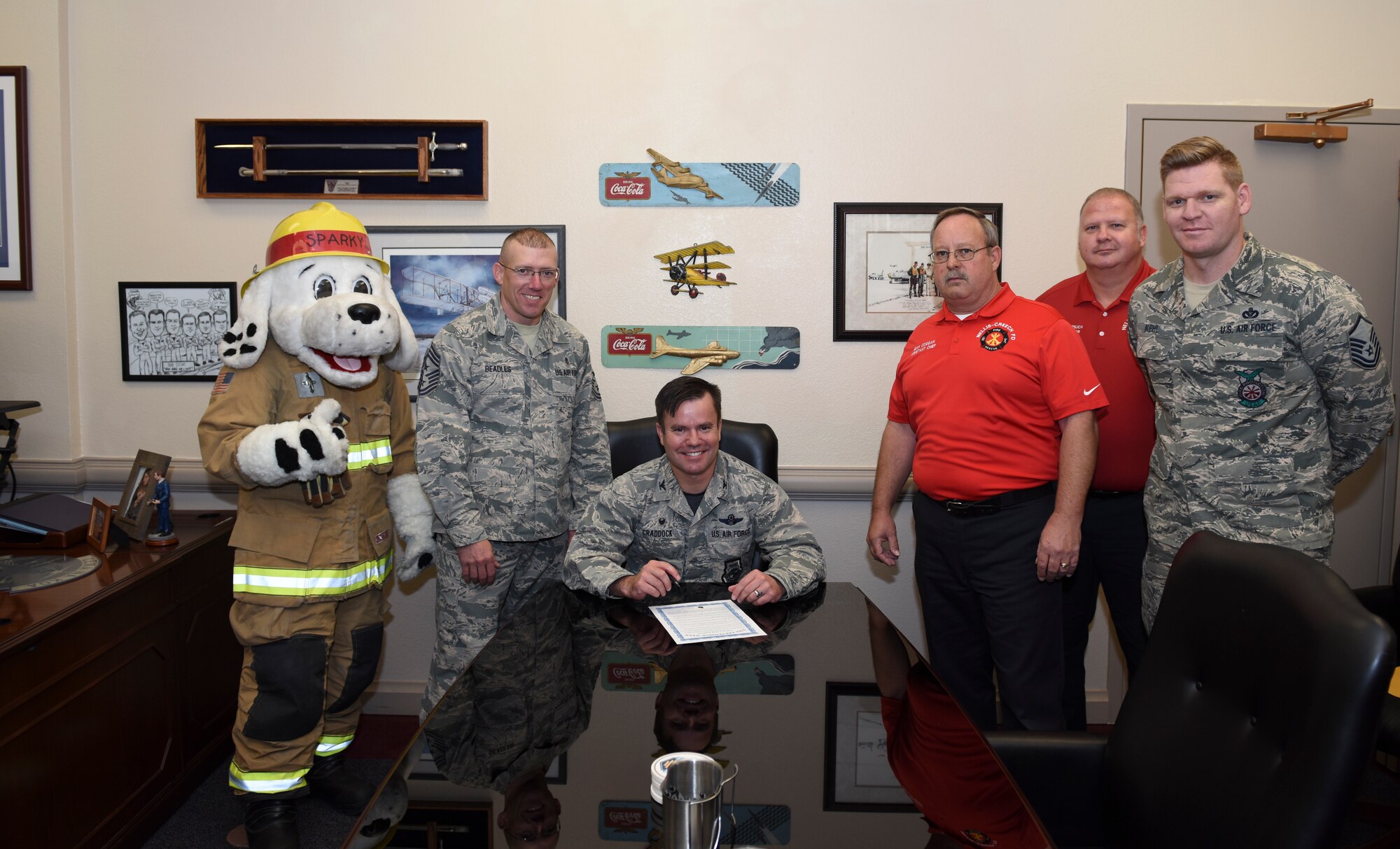 Col. Cavan Craddock, 99th Air Base Wing commander, signs a proclamation to kick off Fire Prevention Week at Nellis Air Force Base, Nevada, Oct. 5, 2018. Fire Prevention Week takes place between Oct. 8 and Oct. 12 and focuses on educating the community about proactive ways to prevent fires. (U.S. Air Force photo by Airman 1st Class Andrew D. Sarver)