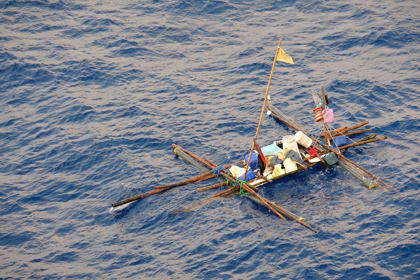 SOUTH CHINA SEA—A makeshift boat filled with minimal supplies sits distressed and adrift in the South China Sea, Oct. 8. Five Filipino fishermen survived for five days aboard a makeshift boat after their fishing boat sank at sea and they were rescued by the crew of USNS Wally Schirra (T-AKE 8).
