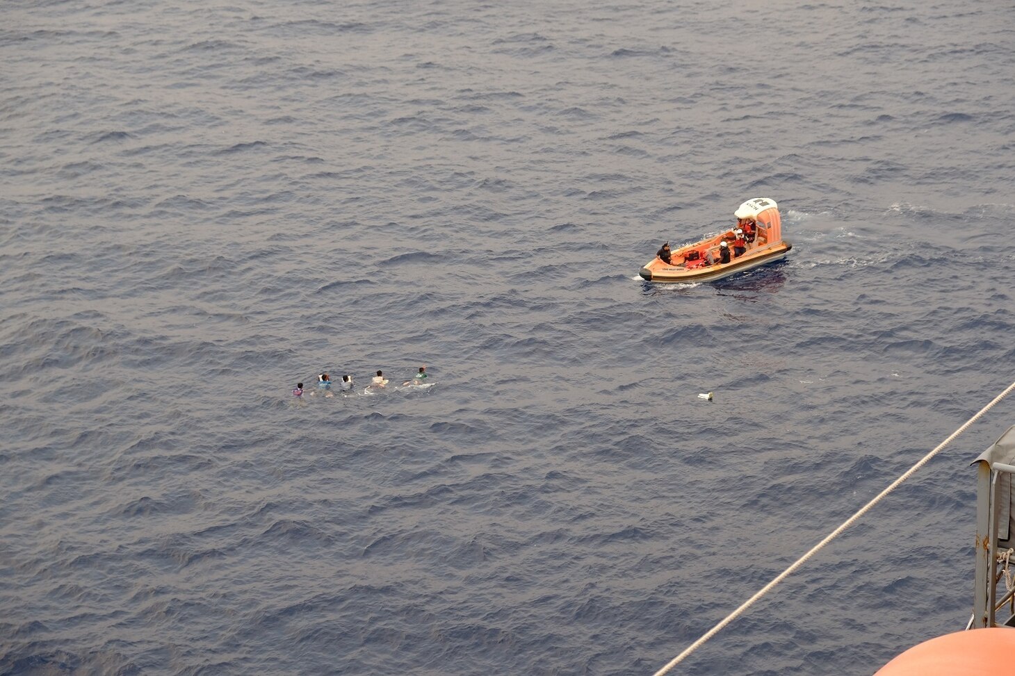 SOUTH CHINA SEA—A rigid-hulled, inflatable boat deployed off the USNS Wally Schirra (T-AKE 8) approaches a group of Filipino fishermen in the South China Sea, Oct. 8. Five Filipino fishermen survived for five days aboard a makeshift boat after their fishing boat sank at sea and they were rescued by the crew of USNS Wally Schirra.