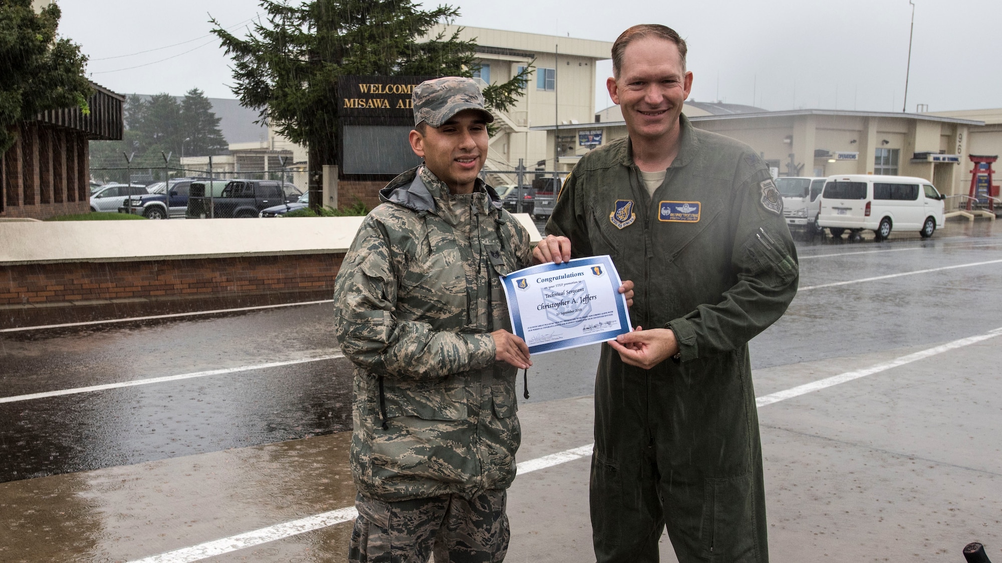 U.S. Air Force Tech. Sgt. Chris Jeffers, left, the 35th Fighter Wing Chapel resource management NCO in charge, and Col. Kristopher Struve, right, the 35th FW commander, pause for a photo during a wing-wide foreign object and debris walk at Misawa Air Base, Japan, Sept. 10, 2018. Jeffers received an on-the-spot promotion from staff sergeant through the Stripes for Exceptional Performers program. (U.S. Air Force photo by Airman 1st Class Collette Brooks)