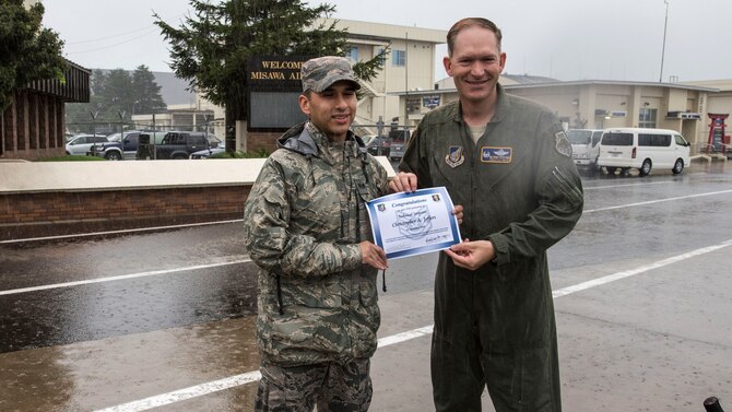 U.S. Air Force Tech. Sgt. Chris Jeffers, left, the 35th Fighter Wing Chapel resource management NCO in charge, and Col. Kristopher Struve, right, the 35th FW commander, pause for a photo during a wing-wide foreign object and debris walk at Misawa Air Base, Japan, Sept. 10, 2018. Jeffers received an on-the-spot promotion from staff sergeant through the Stripes for Exceptional Performers program. (U.S. Air Force photo by Airman 1st Class Collette Brooks)