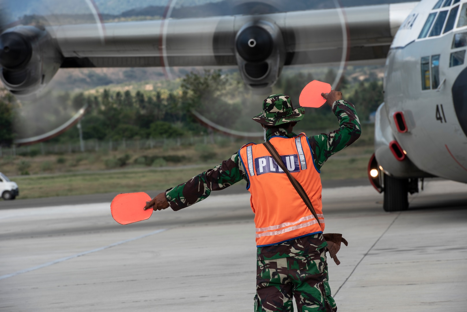 An Indonesian Air Force member taxi an Indonesian Air Force C-130H aircraft to transport supplies and displaced members Oct. 6, 2018. The Indonesian Government and U.S. Agency for International Development are working alongside eight countries to maximize humanitarian relief efforts at staging grounds located in Palu and Balikpapan, Indonesia. (U.S. Air Force photo by Master Sgt. JT May III)