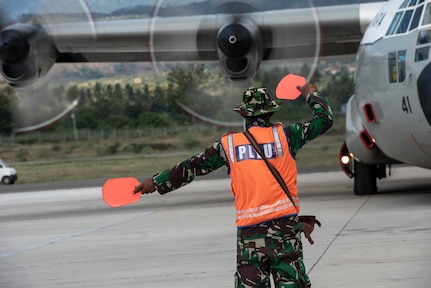 An Indonesian Air Force member taxi an Indonesian Air Force C-130H aircraft to transport supplies and displaced members Oct. 6, 2018. The Indonesian Government and U.S. Agency for International Development are working alongside eight countries to maximize humanitarian relief efforts at staging grounds located in Palu and Balikpapan, Indonesia. (U.S. Air Force photo by Master Sgt. JT May III)