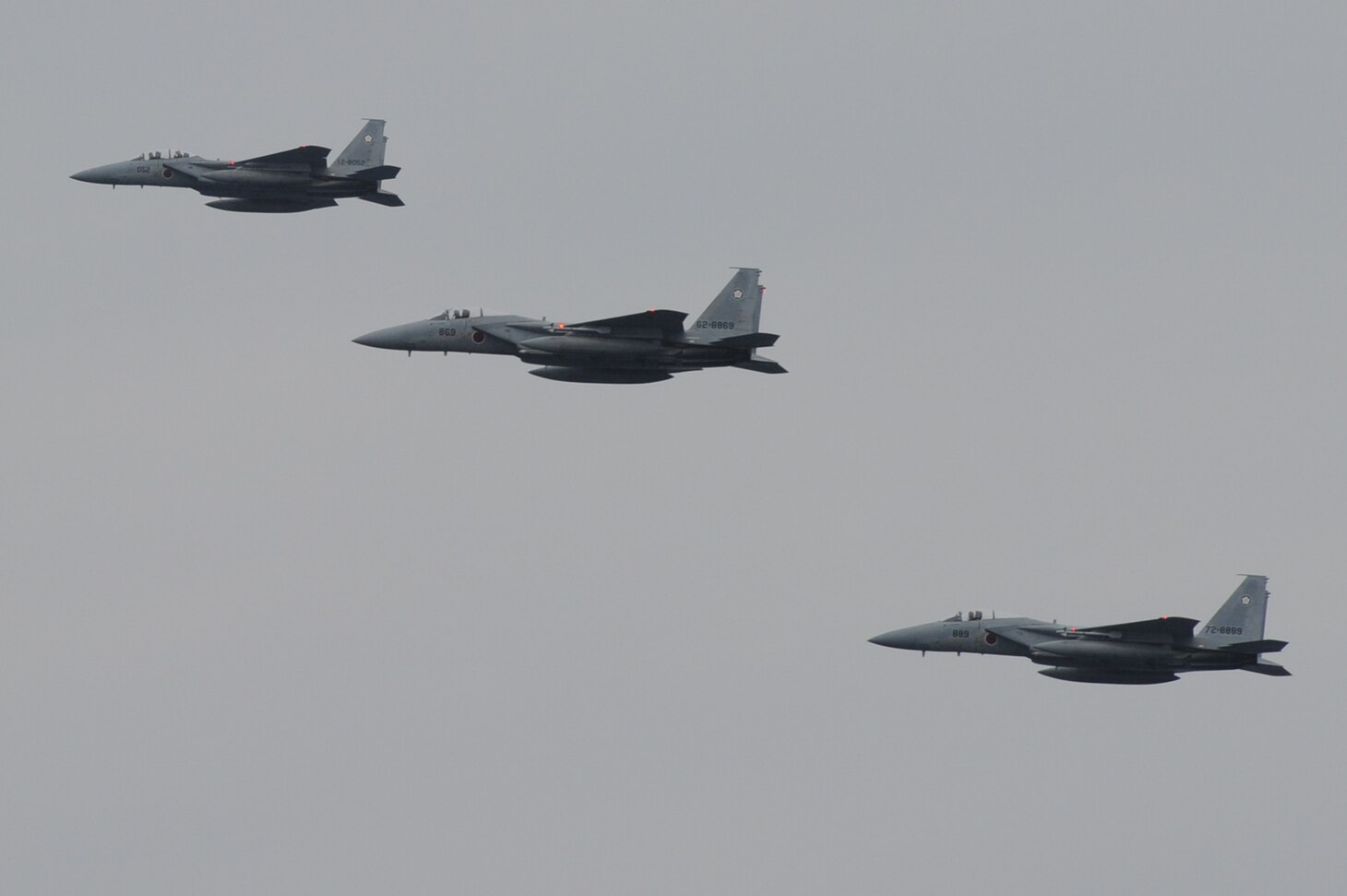 PHILIPPINE SEA (October 10, 2018) F-15Js assigned to the Japan Air Self-Defense Force fly over the Navy's forward-deployed aircraft carrier USS Ronald Reagan (CVN 76) during a cooperative deployment with the ship. Ronald Reagan, the flagship of Carrier Strike Group 5, provides a combat-ready force that protects and defends the collective maritime interests of its allies and partners in the Indo-Pacific region.