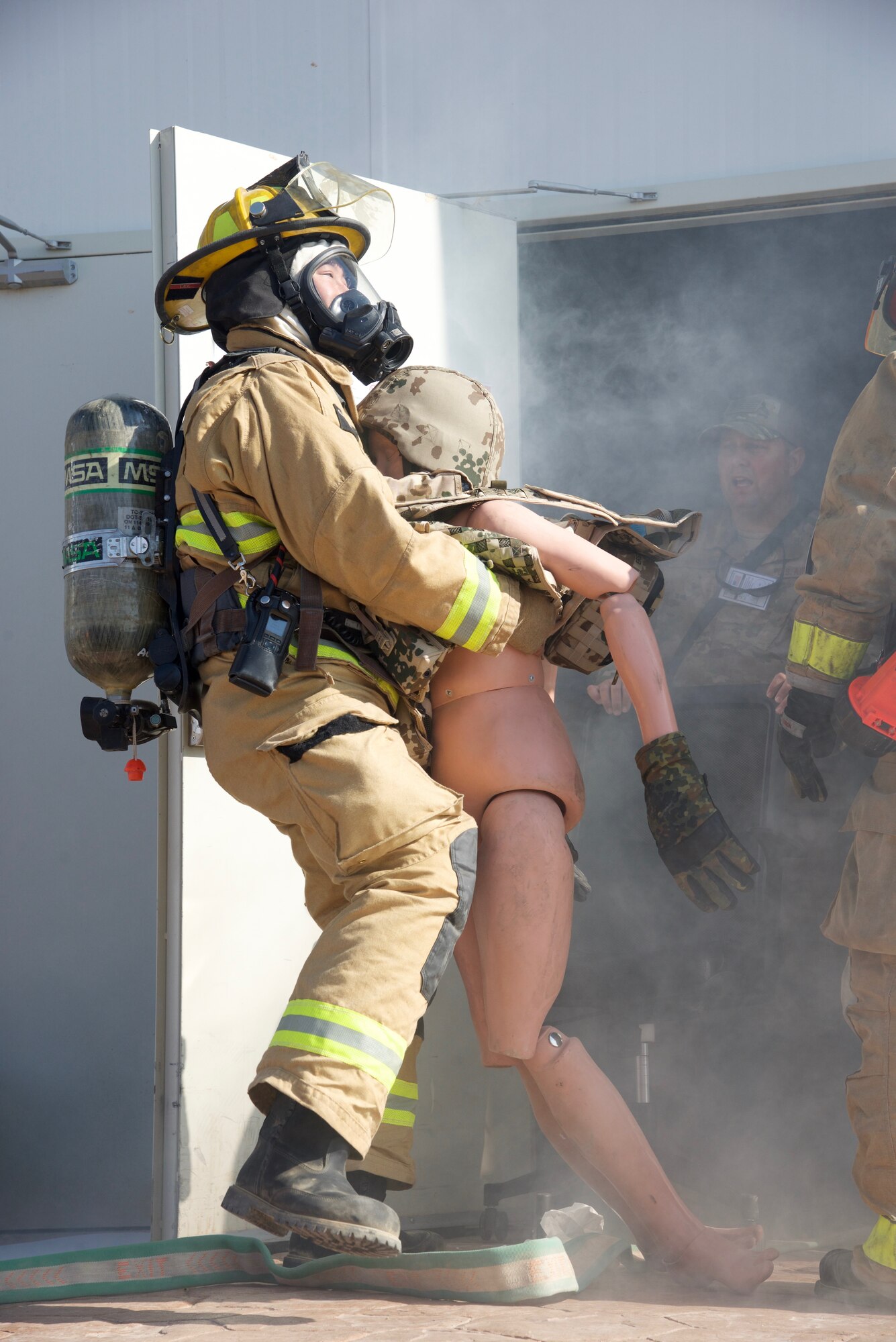 Tech. Sgt. Danny Lee, 332nd Expeditionary Civil Engineer Fire Department firefighter, drags an 80-lb dummy out of a building during a simulated fire exercise, Sept. 22, 2018, at an undisclosed location in Southwest Asia. The 332nd CES Fire Department provides fire prevention, firefighting, rescue, and emergency response services for joint and coalition partners here.