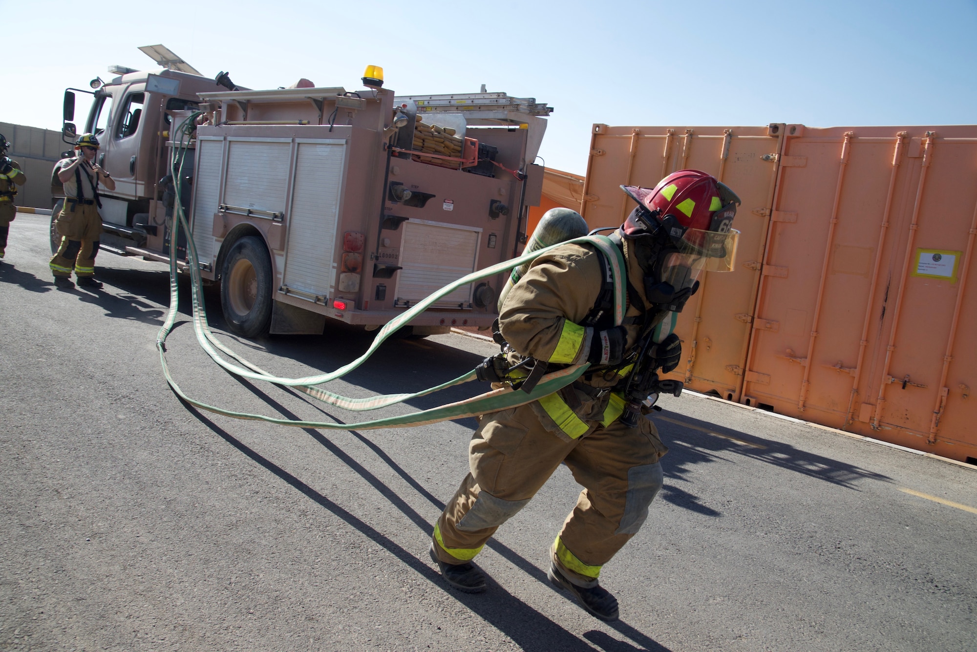 Staff Sgt. Vincent Kinard, 332nd Expeditionary Civil Engineer Squadron Fire Department firefighter, prepares a firehose for a simulated fire during an exercise, Sept. 22, 2018, at an undisclosed location in Southwest Asia.