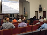 DLA Distribution commanding officer Navy Supply Corps Rear Adm. Kevin Jones recognizes outstanding employees during a town hall at DLA Distribution Bahrain.