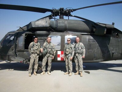 New York Army National Guard Maj. Stephen Carson, second from left, is seen with his aeromedical flight crew at Udairi Airfield after a mission during his deployment to Kuwait in 2013-14. Carson, then a captain, served as a Physician’s Assistant in support of the New York Army National Guard’s 642nd Support Battalion, part of the 42nd Combat Aviation Brigade.