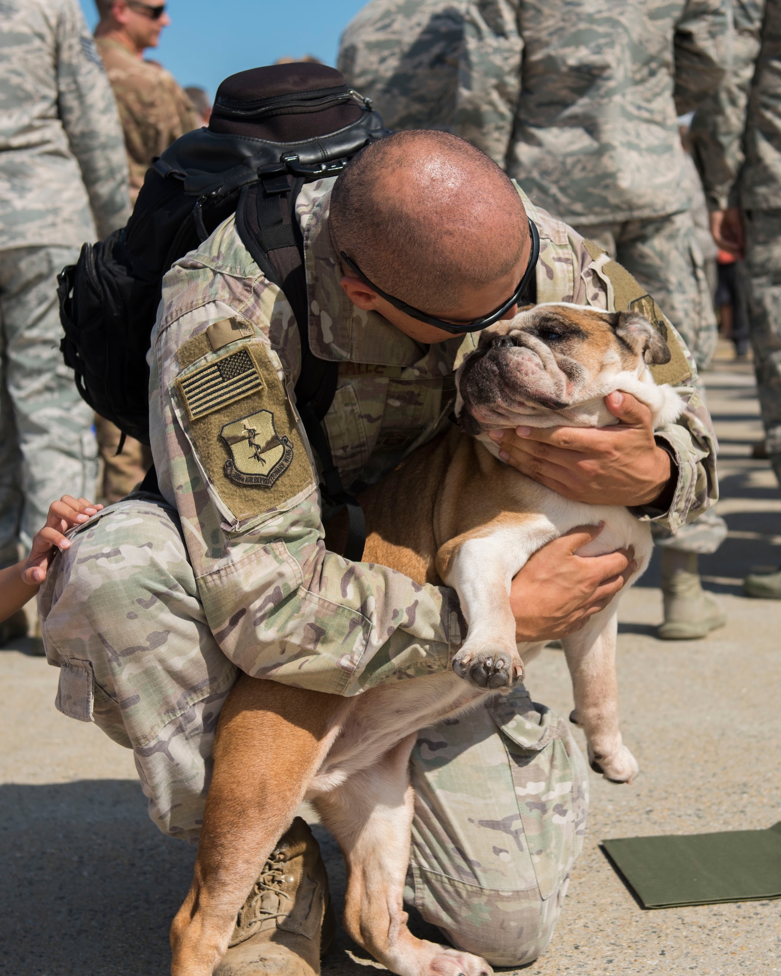 U.S. Air Force Master Sgt. David Gonzalez, 1st Maintenance Squadron production superintendent, hugs his dog, Roxy, at Joint Base Langley-Eustis, Virginia, Oct. 9, 2018.