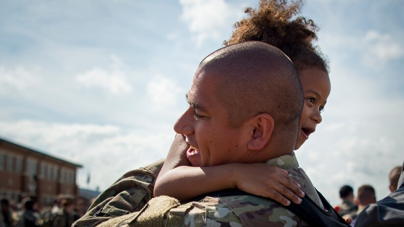 U.S. Air Force Master Sgt. Victor Chavez, 1st Maintenance Squadron fabrication flight chief, embraces his daughter upon return to Joint Base Langley-Eustis, Virginia, Oct. 9, 2018.