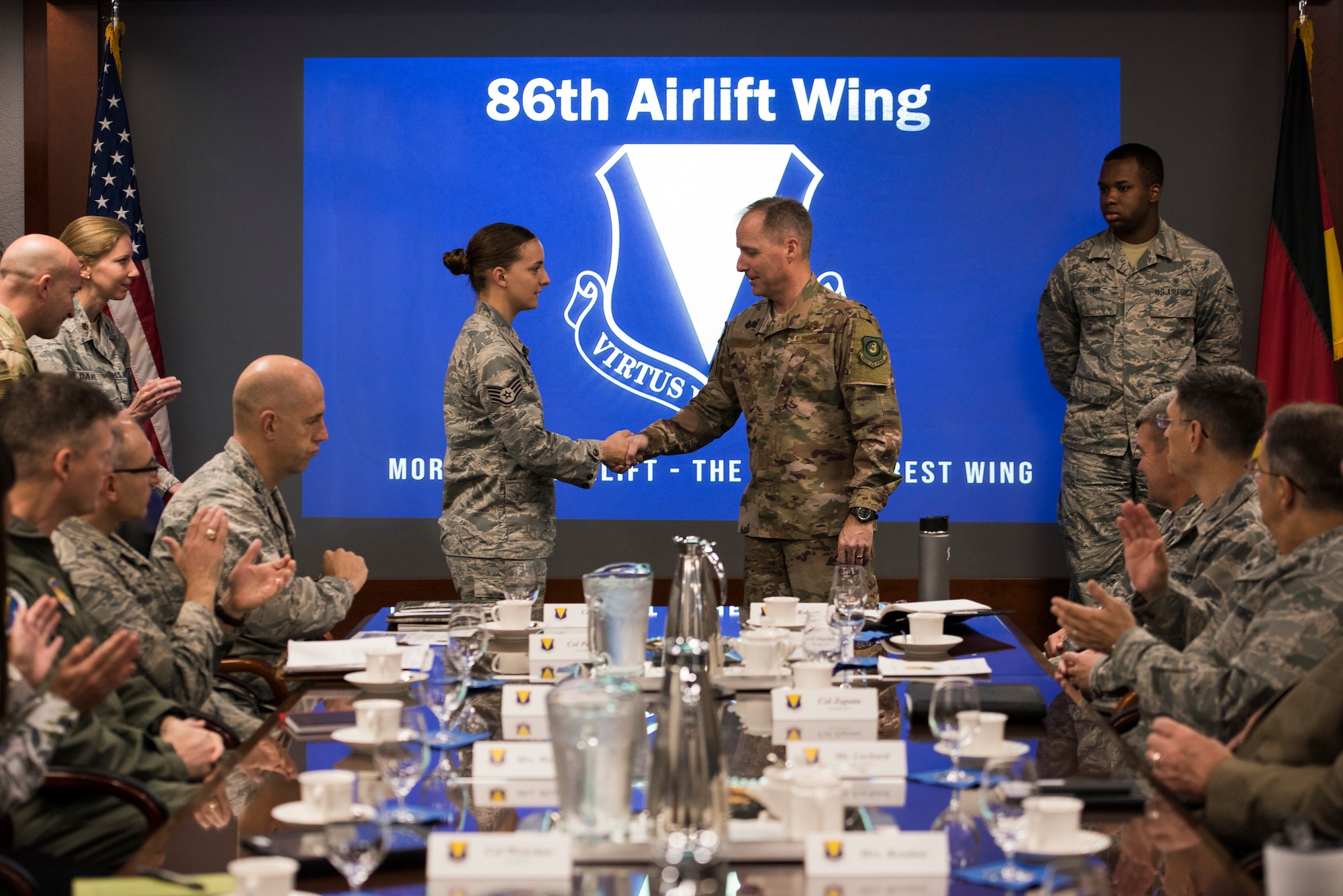 U.S. Air Force Maj. Gen. John Wood, Third Air Force commander, coins Staff Sgt. Cara Holder, 86th Logistics Readiness Squadron noncommissioned officer in charge of deployment during the a tour of the 86th Airlift Wing Oct. 5, 2018, at Ramstein Air Base, Germany. Wood coined outstanding performers from units assigned to the 86th. (U.S. Air Force photo by Senior Airman Devin M. Rumbaugh)