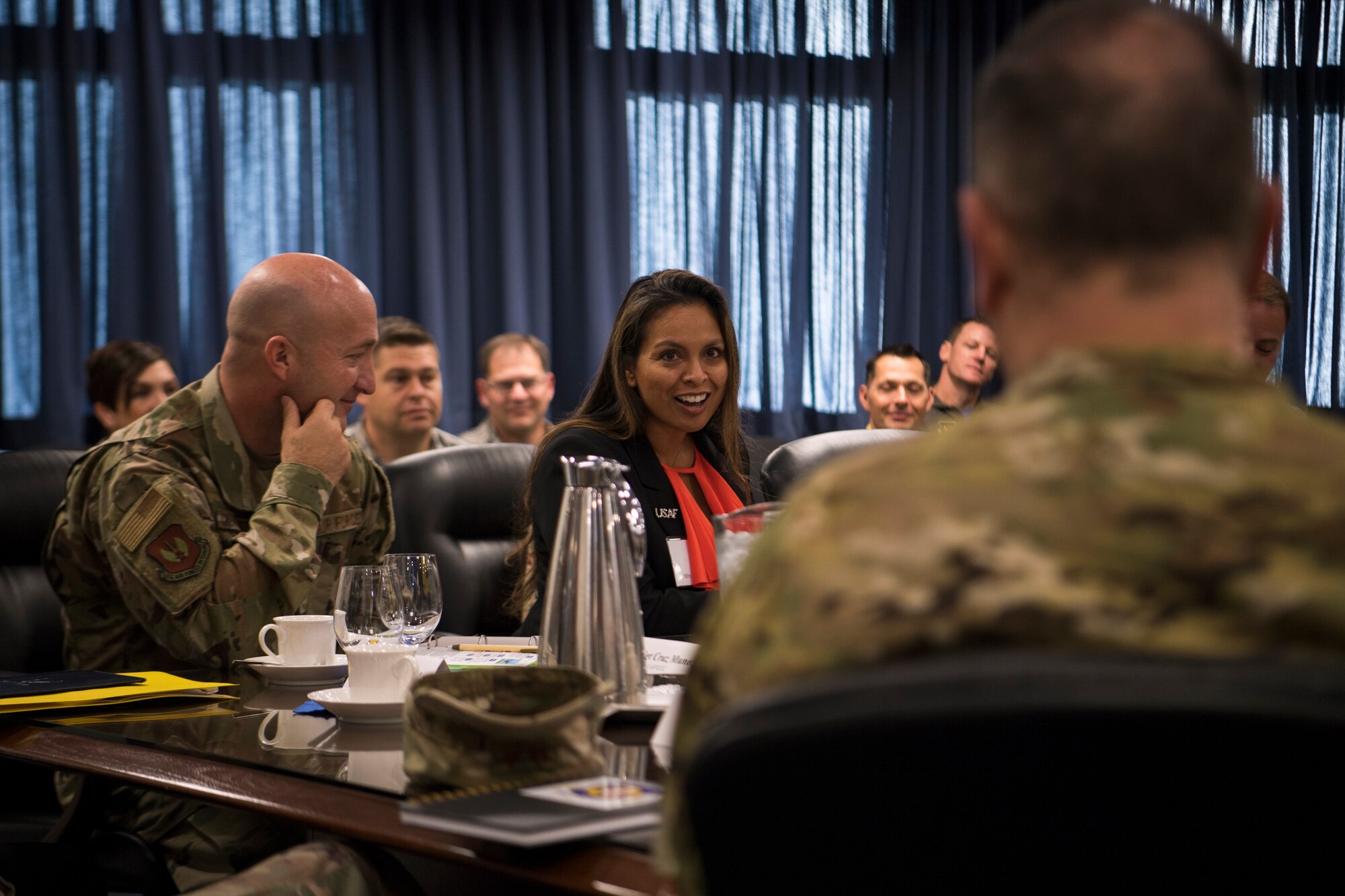 Lora Cruz Munoz, spouse of Third Air Force Command Chief Master Sgt. Anthony Cruz Munoz, asks Brig. Gen. Mark August, 86th Airlift Wing commander, a question during a tour of the 86th AW Oct. 5, 2018, at Ramstein Air Base, Germany. Key spouses attended a separate immersion tour throughout the day. (U.S. Air Force photo by Senior Airman Devin M. Rumbaugh)