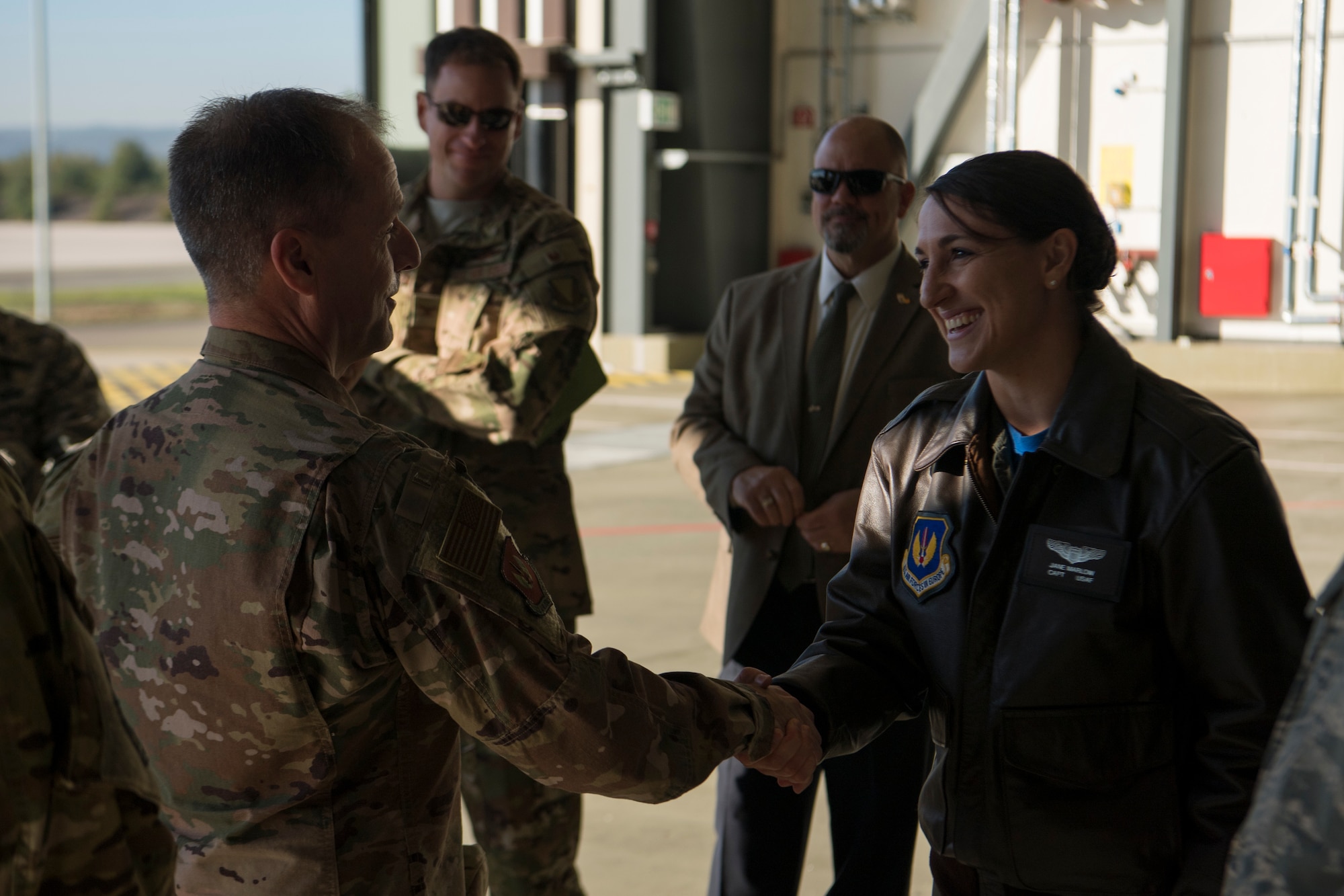 U.S. Air Force Maj. Gen. John Wood, Third Air Force commander, coins Capt. Jane Marlow, 37th Airlift Squadron tactics officer, during an immersion tour of the 86th Airlift Wing Oct. 5, 2018, at Ramstein Air Base, Germany. Marlow spoke about the capabilities of the C-130J Super Hercules mission across Europe. (U.S. Air Force photo by Senior Airman Devin M. Rumbaugh)