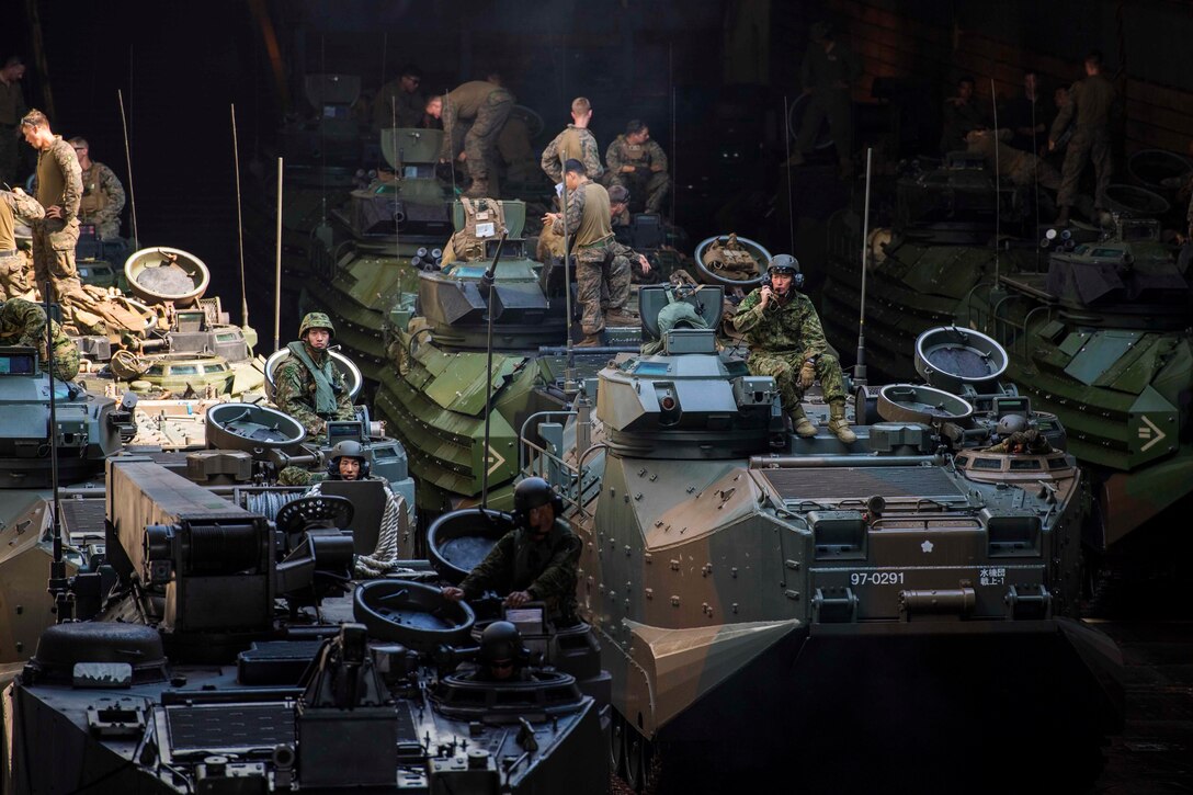 Soldiers from the Japan Ground Self-Defense Force Amphibious Rapid Deployment Brigade and Marines, attached to the 31st Marine Expeditionary Unit, stand by in the well deck of the amphibious dock landing ship USS Ashland after completing humanitarian training and disaster relief training as part of an exercise for KAMANDAG 2. KAMANDAG 2 is a military training exercise led by Philippines between the Armed Forces of the Philippines and U.S. military, along with participants from the Japan Self-Defense Force featuring military-to-military exchanges through various training events, capabilities development training, and humanitarian and civic assistance projects. KAMANDAG is an acronym for the Filipino phrase “Kaagapay Ng Mga Mandirigma Ng Dagat,” which translates to “Cooperation of Warriors of the Sea,” highlighting the partnership between the Philippine and United States Militaries.
