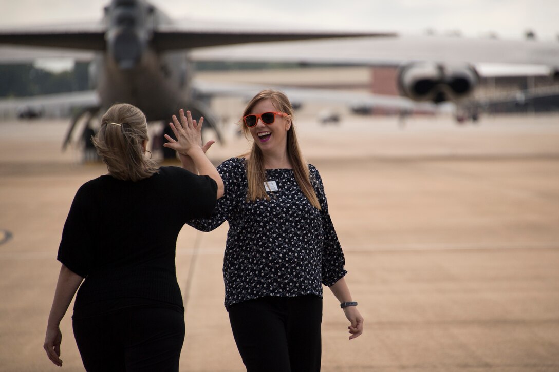 Two local civic leaders from the Shreveport-Bossier City area celebrate on the flight line at Barksdale Air Force Base, Louisiana, Oct. 9, 2018.  They were part of a group learning more about the Air Force mission in the community.  All leaders toured a B-52 Stratofortress and had the opportunity to speak with active-duty and Reserve Citizen Airmen. (U.S. Air Force photo by Master Sgt. Ted Daigle)