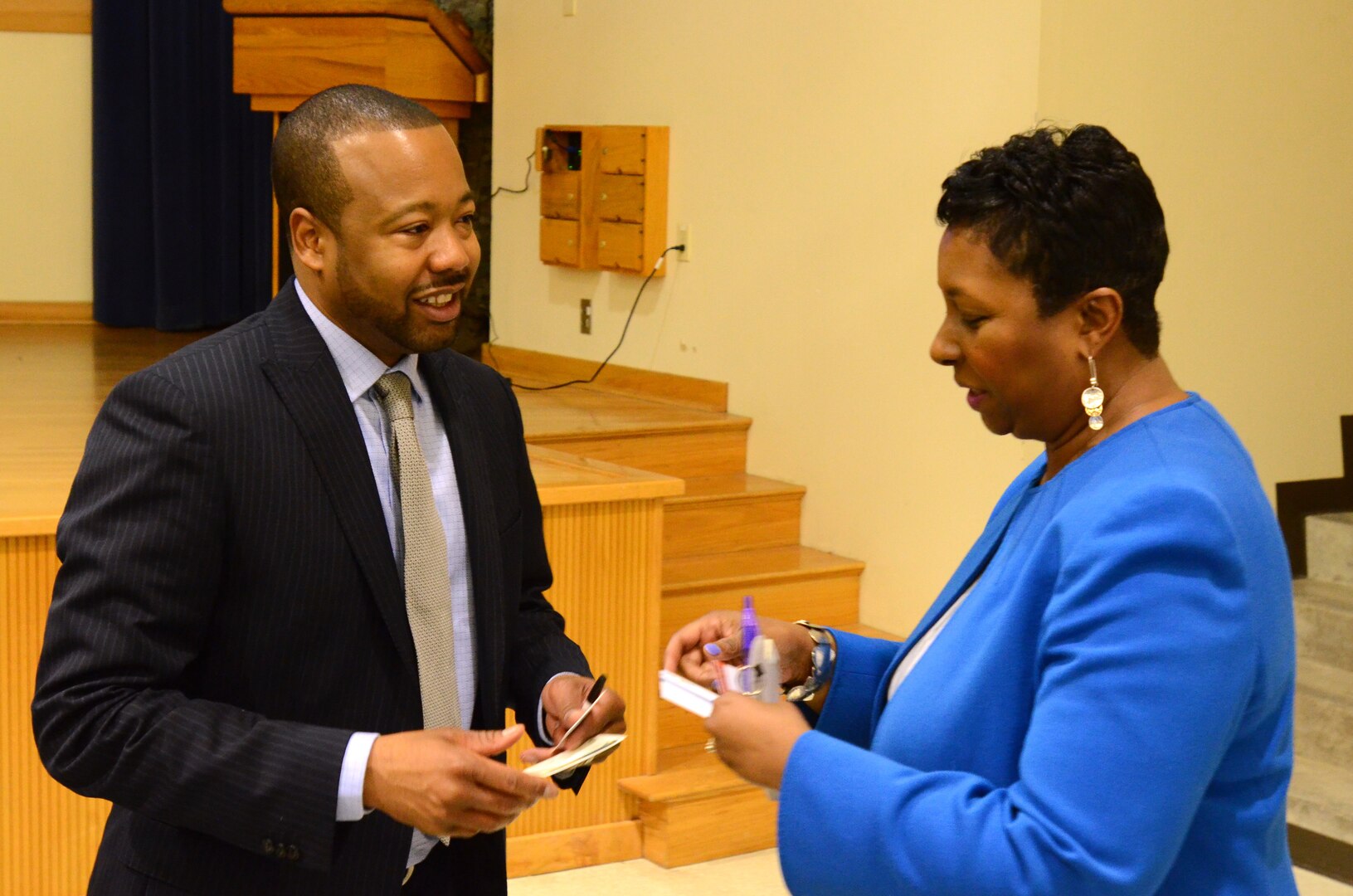 Aundair Kinney, the director for the Military and Installation Contracting Command-Fort Hood (right) exchanges business cards with a contractor at the Mission Command Training Center April 18.  The MICC hosted its annual contract acquisition forum open house that provides a forecast of upcoming contracts that will need to be fulfilled.