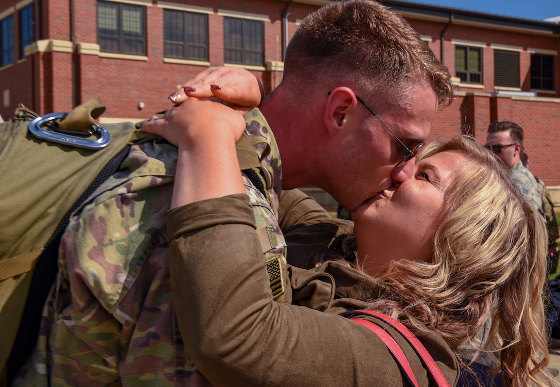 U.S. Air Force Staff Sgt. Justin Smith, 1st Maintenance Squadron load crew chief, kisses his wife Anna after returning to Joint Base Langley-Eustis, Virginia, Oct. 9, 2018. During a 6-month deployment, the U.S. Air Force Airmen and F-22 Raptors delivered air superiority during combat operations, supporting Operation Inherent Resolve and the fight against enemy forces in Iraq and Syria. (U.S. Air Force Photo by Staff Sgt. Carlin Leslie)