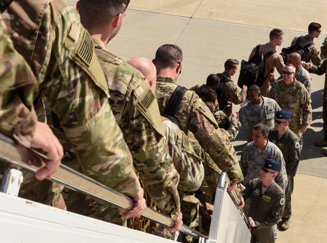 1st Fighter Wing senior leaders welcome U.S. Air Force Airmen from the 94th Fighter Squadron home at Joint Base Langley-Eustis, Virginia, Oct. 9, 2018.  During a 6-month deployment, the U.S. Air Force Airmen and F-22 Raptors delivered air superiority during combat operations, supporting Operation Inherent Resolve and the fight against enemy forces in Iraq and Syria. (U.S. Air Force Photo by Staff Sgt. Carlin Leslie)