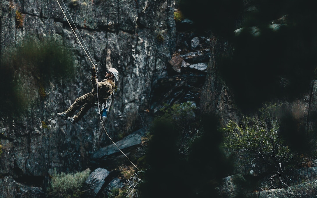 A U.S. Army Special Forces soldier with Operational Detachment Alpha conducts a tyrolean traverse over an 80-foot gorge, aboard Marine Corps Mountain Warfare Training Center, Bridgeport, Calif., July 23, 2018. Any special operations force element that comes to MCMWTC has the opportunity to do their list of schools; ranging from Assault Climber, Mountain Medicine, Mountain Sniper and others, or they can program their own training through use of an internal mountaineering subject matter expert. (U.S. Marine Corps photo by Lance Cpl. Rachel K. Young)