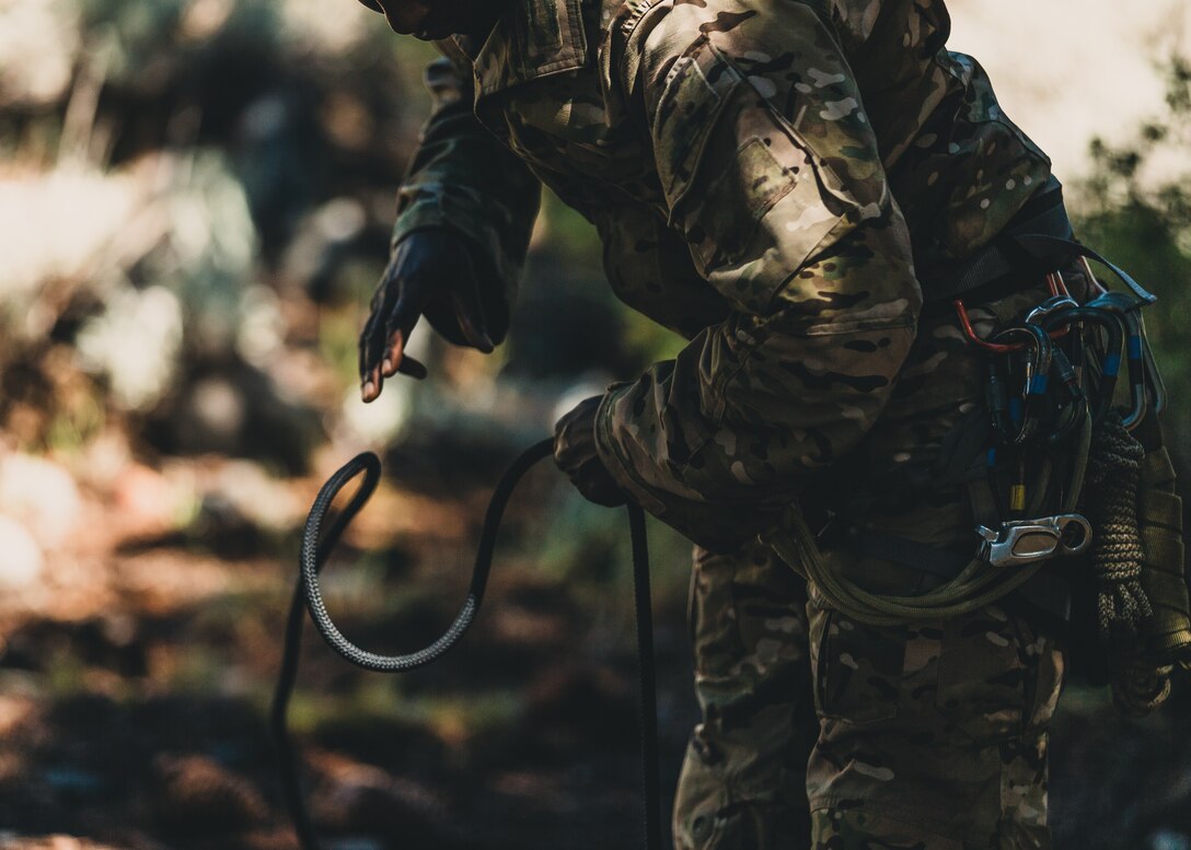 A U.S. Army Special Forces soldier with Operational Detachment Alpha prepares climbing rope for a training exercise involving a tyrolean traverse, aboard Marine Corps Mountain Warfare Training Center, Bridgeport, Calif., July 23, 2018. Any special operations force element that comes to MCMWTC has the opportunity to do their list of schools; ranging from Assault Climber, Mountain Medicine, Mountain Sniper and others, or they can program their own training through use of an internal mountaineering subject matter expert. (U.S. Marine Corps photo by Lance Cpl. Rachel K. Young)