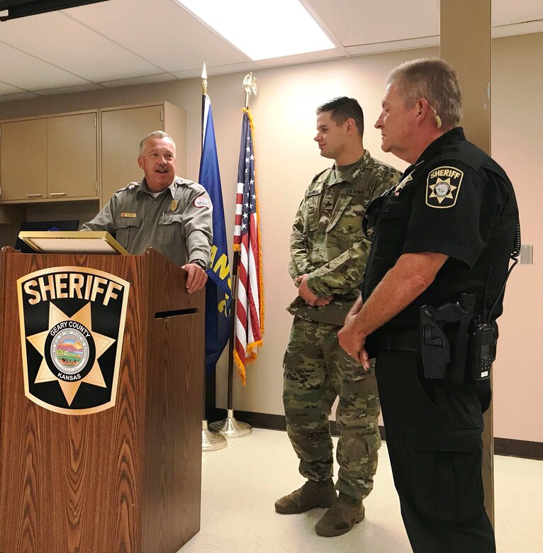 Ken Wenger, left, Milford Lake park manager, presented Geary Co. Sheriff's Deputy Rick Parsons and Pfc. Chance Harriss, stationed at Fort Riley, Kan., with 'Act of Heroism' awards at the Geary County Sheriff's Office October 9, 2018.