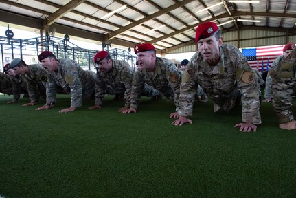 Members of the  Special Warfare Training Wing honor the fallen with memorial push-ups after the SWTW activation ceremony at Joint Base San Antonio-Medina Base, Texas Oct. 10, 2018. The mission of the new wing is to select, train, equip, and mentor Airmen to conduct global combat operations in contested, denied, operationally limited, and permissive environments under any environmental conditions.(U.S. Air Force photo by Andrew C. Patterson)