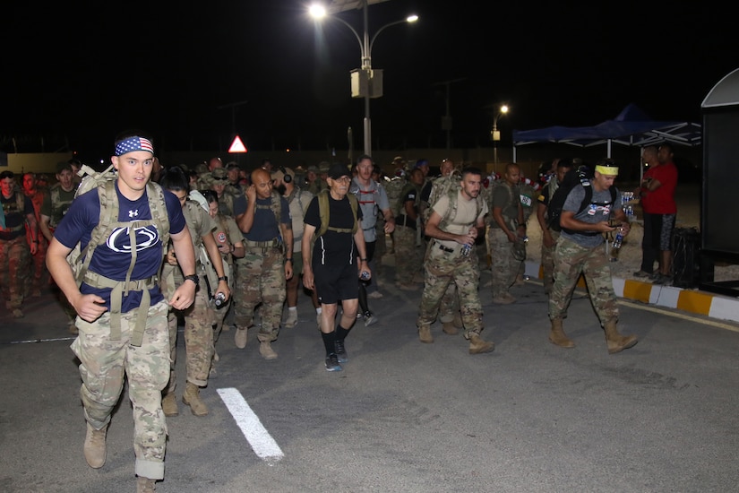 Participants in March For The Fallen–Jordan leave the starting line at 5 a.m. on Oct. 6, 2018. Those rucking in the competitive category attempted to cover 28 miles in less than 11 hours while carrying 35 pounds. Other Task Force Spartan service members and civilians opted to undertake the trek without rucksack, duty uniform trousers and boots.