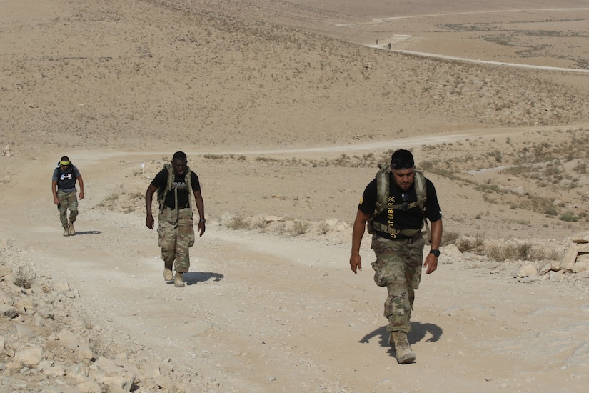 Spc. Mauro Guzman (right) and Sgt. Levi Kassiano, both with Alpha Company, 1st Squadron, 18th Cavalry Regiment; and Sgt. 1st Class Michael Campagna, with 157 Military Engagement Team, make their way up a steep grade during the March For The Fallen shadow event Oct. 6, 2018. The 28-mile March For The Fallen ruck march originated in Pennsylvania seven years ago with the 28th Infantry Division.