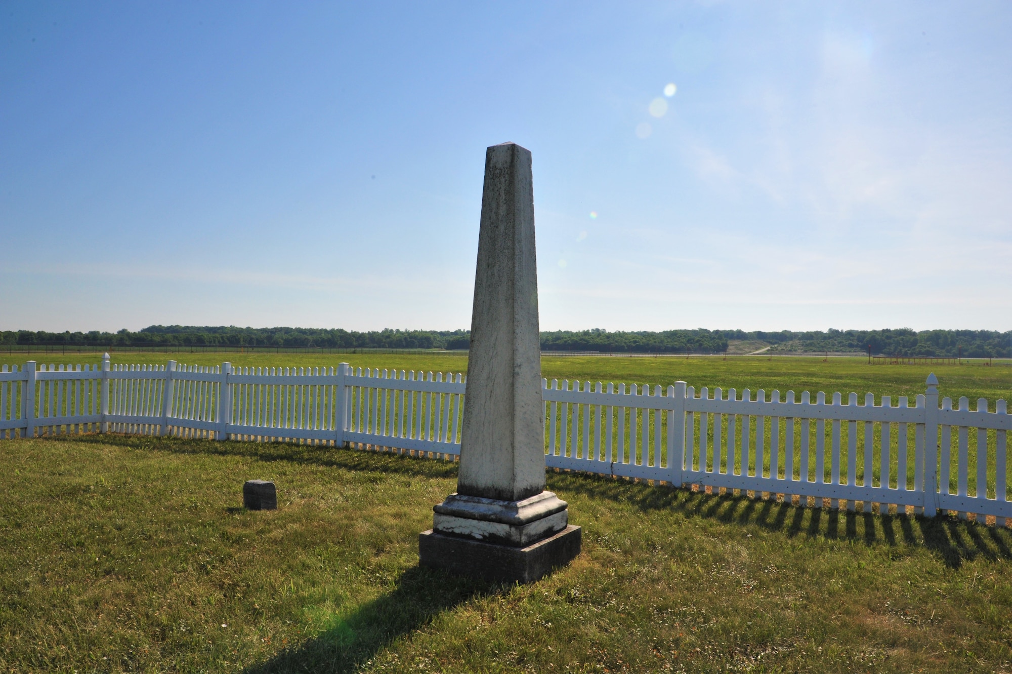 A grave marker at Cox Family Cemetery, one of few obstructions in the air field at Wright-Patterson Air Force Base, is a reminder of the historic town of Osborne. (U.S. Air Force Photo/Isa Velez)