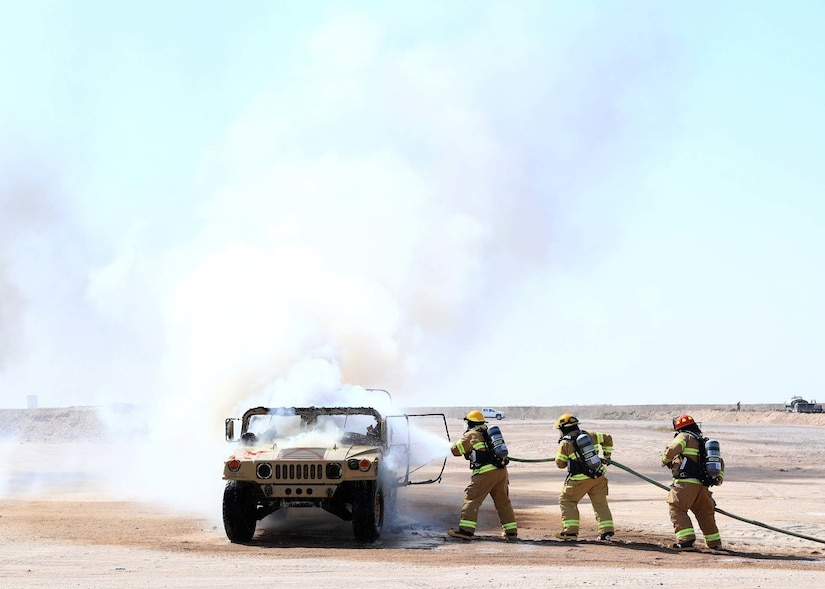 Fire fighters respond to a vehicle fire during Mass Casualty Training Exercise hosted by Area Support Group-Kuwait at Camp Buehring, Kuwait, September 26, 2018. Exercises like these help prepare Emergency Management Services (EMS) personnel personnel for real life situations involving minor to life threatening injuries.