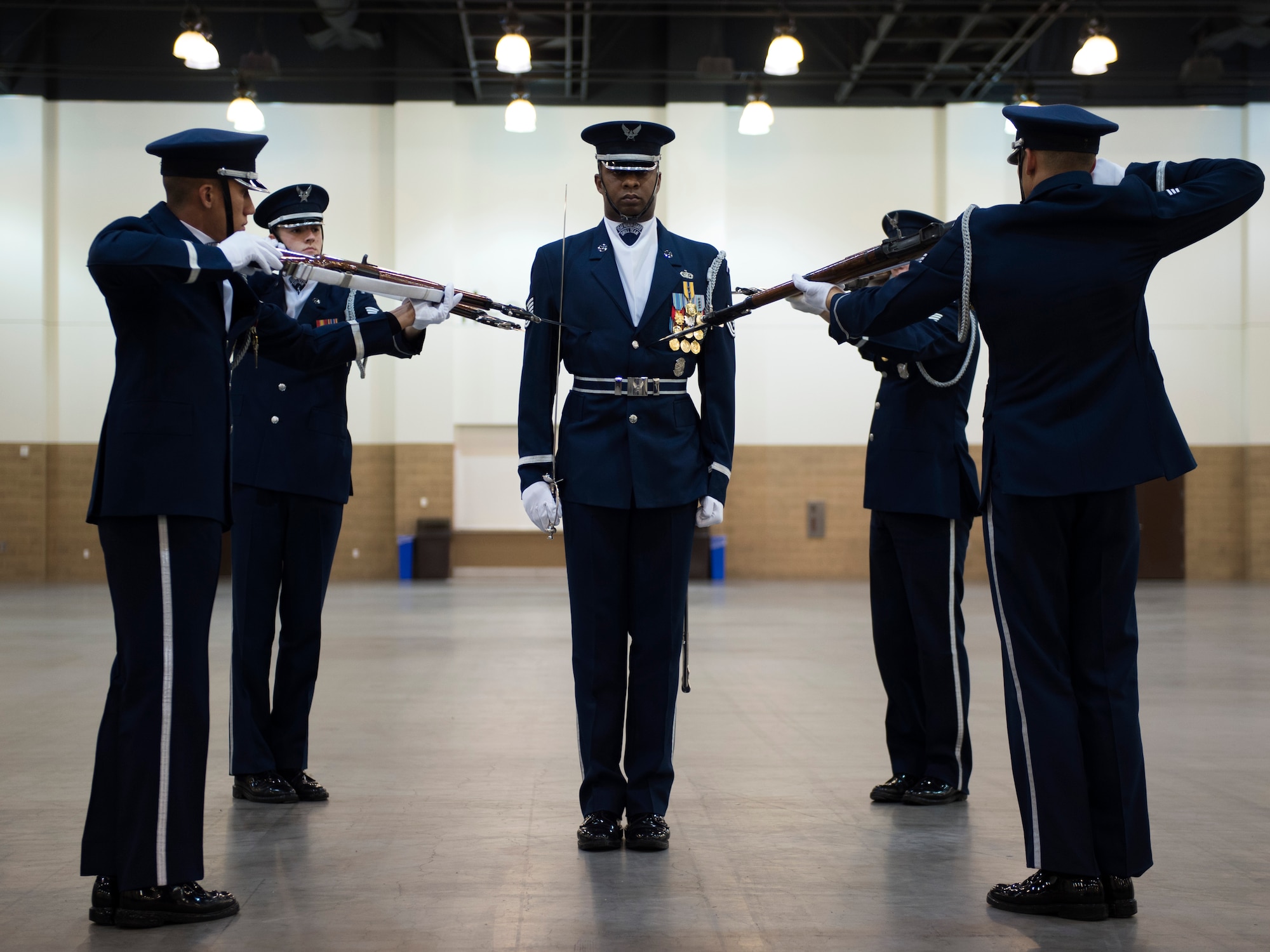 United States Air Force Honor Guard Drill Team performances feature a professionally choreographed sequence of show-stopping weapon maneuvers, precise tosses, complex weapon exchanges, and a walk through the gauntlet of spinning weapons. The Drill Team members perform over 100 times a year at various venues all over the world. (U.S. Air Force Photos/Senior Airman Philip Bryant)