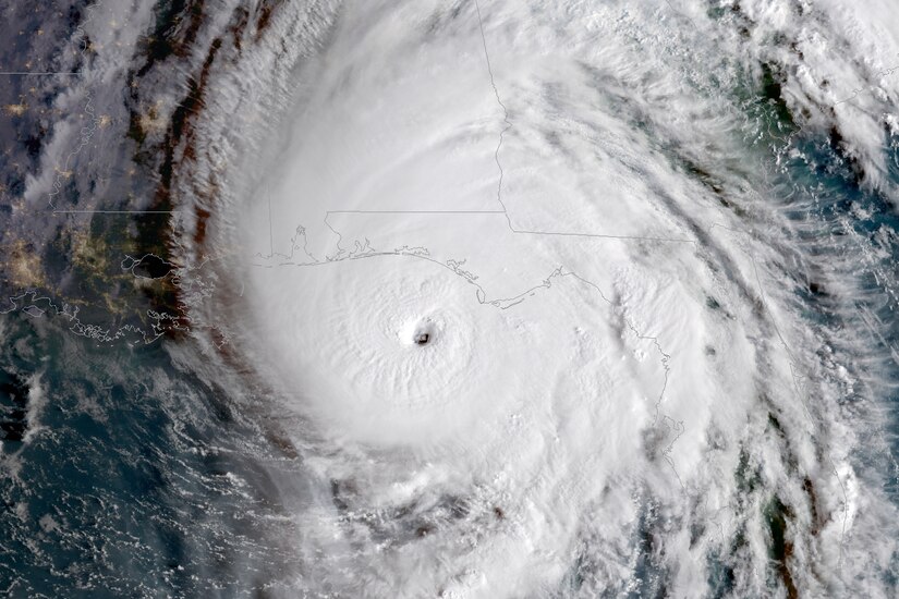 A storm system swirls over the Florida panhandle in a satellite view.